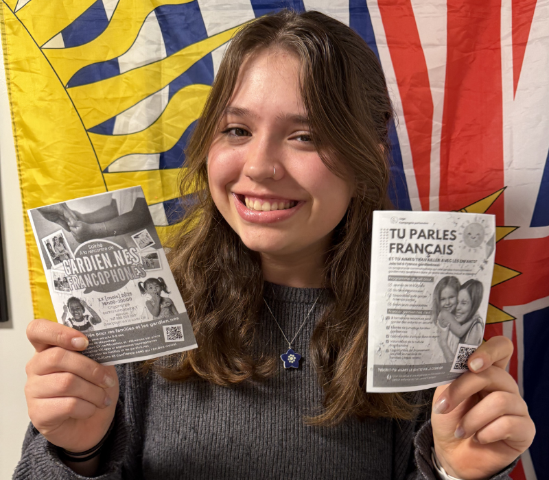 Winner holding up flyers